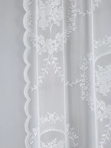 Close-up of white French lace curtain featuring floral jacquard and scalloped edges