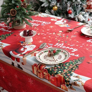 Festive red Christmas tablecloth featuring Santa Claus and tree patterns for dining decor