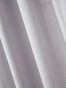 Macro detail of luxury white sheer curtain fabric with elegant weaving texture