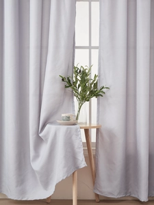 Detail of light gray striped sheer curtain with elegant drape and modern home decor scene