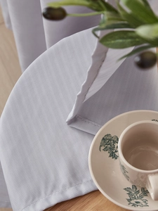 Detail of light gray sheer curtain fabric with premium stitching and fine texture