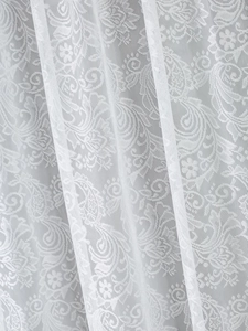 Detailed close-up of white French lace curtain featuring floral and Paisley patterns