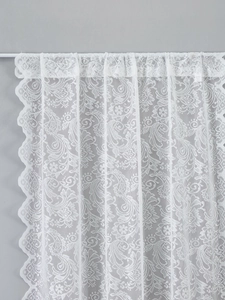 Close-up of white French lace door curtain with paisley patterns and scalloped edges