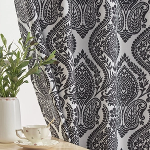 Detail of high-density blackout curtain with vintage black paisley print and fabric texture