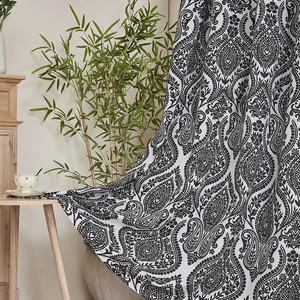 Detail of black and white damask print curtain fabric showing thick texture and drape