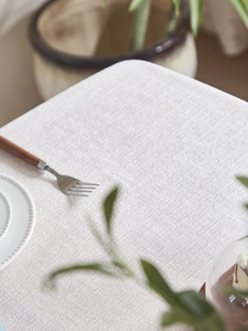 Macro detail of Nordic beige linen tablecloth with woven texture and premium fabric grain