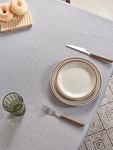 Detailed view of grey textured tablecloth with modern Nordic minimalist woven pattern