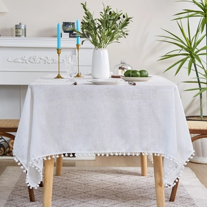 White linen tablecloth with pom-pom edges, rectangular Nordic style table cover
