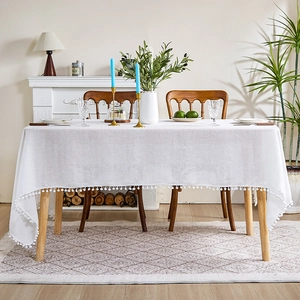 Minimalist white textured linen tablecloth with elegant pom-pom fringe for home decor