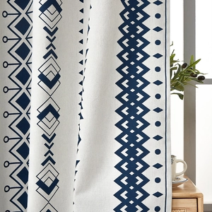 Detail of bohemian curtain with blue geometric patterns on white linen fabric texture