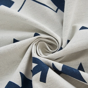 Detailed close-up of blue geometric patterns on beige linen blackout curtain fabric