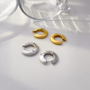 Polished gold and silver thick hoop earrings with elegant water ripple shadows