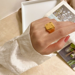 Bague chevalière dorée épaisse avec texture martelée portée à la main style chic
