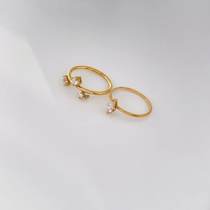 Detail of 18K gold plated titanium rings with zircon marquise and cluster stones