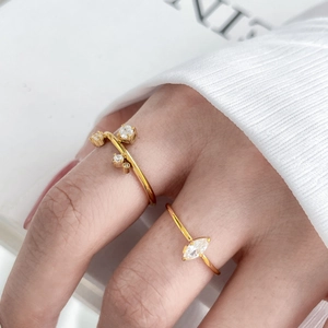 Close-up of 18K gold-plated rings with marquise and round zircon inlays on model