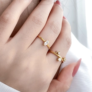 Detail of 18K gold-plated titanium rings featuring marquise zircon and asymmetric stones