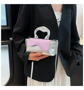 Detail of silver metallic handbag with lavender wavy flap and chrome handle
