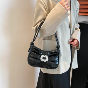 Elegant black ruched shoulder bag with sparkling rhinestone floral buckle detail