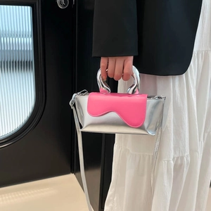 Modern silver and pink color block handbag with metallic circular handles and a shoulder strap