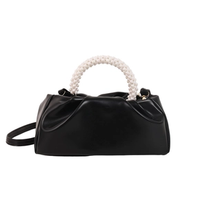 Minimalist black cloud bag with white pearl handle and pleated faux leather design