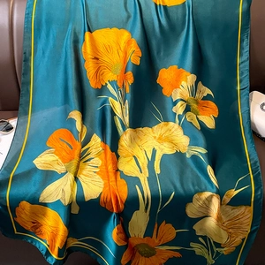 Elegant silk floral scarf in dark green and orange for beach sunscreen and summer fashion