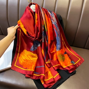 Red silk scarf with large orange floral prints and yellow edges for summer beach wear