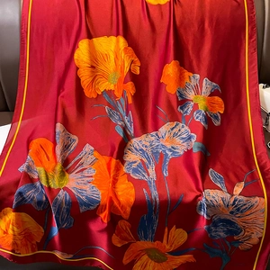 Red silk satin scarf featuring orange and blue floral patterns for beach vacation