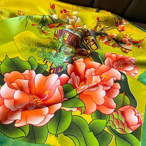Detail of silk scarf showing Chinese floral prints and smooth, glossy fabric texture