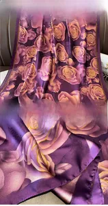 Detailed close-up of premium silk-like scarf featuring rose patterns and reinforced edges