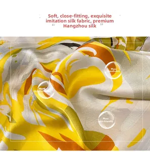 Detail of silk-like satin fabric showing smooth texture and yellow floral patterns