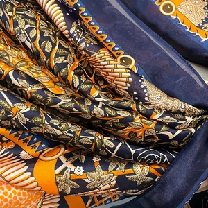 Tropical leaf print oversized silk scarf with navy blue and orange geometric patterns