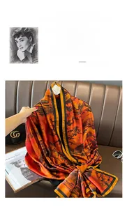 Detail of elegant silk scarf with abstract mountain print in orange and brown tones