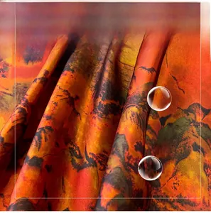 Detailed texture of orange mountain landscape print on soft faux silk scarf fabric