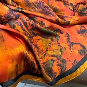 Artistic landscape print faux silk scarf in warm orange and caramel tones for women