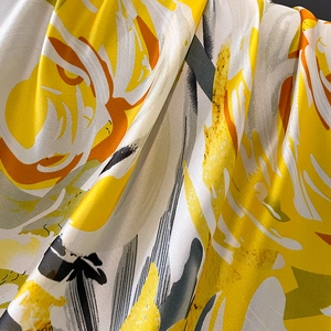 Elegant floral silk scarf for women featuring vibrant yellow and white abstract patterns