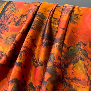 Elegant Chinese landscape silk scarf with vibrant orange mountain print and satin finish