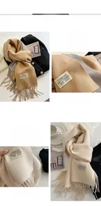 Detail of double-sided cashmere-like scarf showing khaki and grey tones with fringe edges
