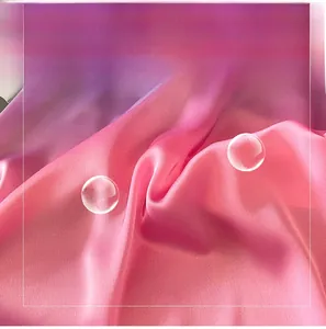 Detail of pink gradient faux silk fabric showing glossy texture and breathable soft fibers