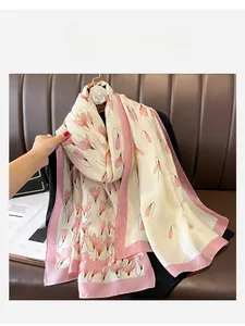 Detailed view of pink floral tulip patterns and soft pink borders on silk-feel scarf