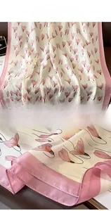 Detailed view of floral silk scarf showing premium stitching and smooth satin texture