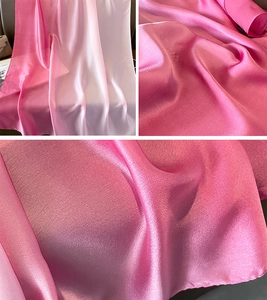 Macro detail of high-quality gradient satin scarf showing soft pink twill weave and silk texture