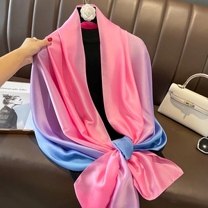 Detail view of the elegant pink, purple and blue gradient satin scarf texture on a display