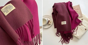 Close-up of double-sided cashmere scarf with tassels and high-quality woven brand label