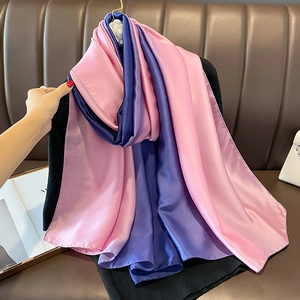 Detail of pink and purple gradient satin scarf showing soft texture and glossy finish