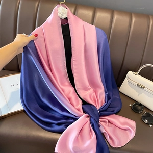 Detail of silk-like satin scarf with navy and pink contrast and camellia hook detail