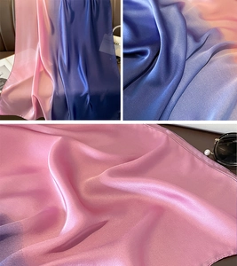 Detailed macro view of the gradient satin silk scarf showing soft pink to royal blue transitions