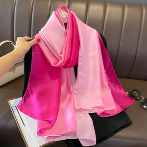 Detail view of pink gradient satin scarf with silky texture and elegant flowing finish