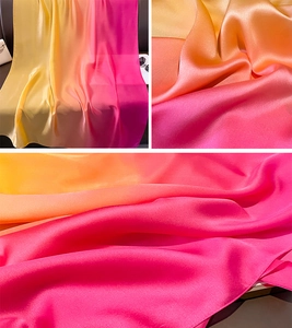 Detailed view of the gradient satin silk scarf with smooth texture and vivid orange tones