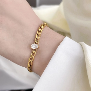 18K gold plated titanium cuban chain bracelet featuring a pear cut zircon stone