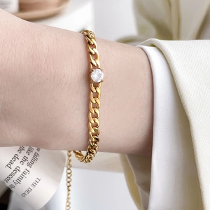 Macro view of 18K gold-plated Cuban link bracelet featuring a round zircon and adjustable chain